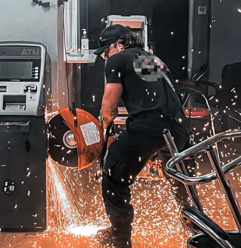Jesse Carlson using a rescue saw with sparks