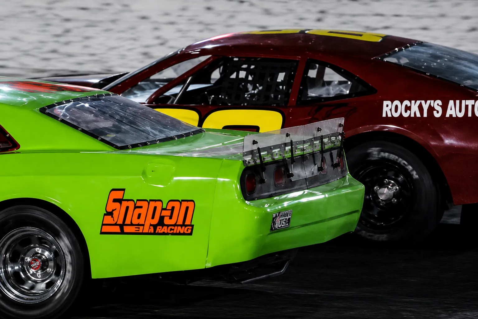 David Rothrock racing side by side in the red number 88 Camaro