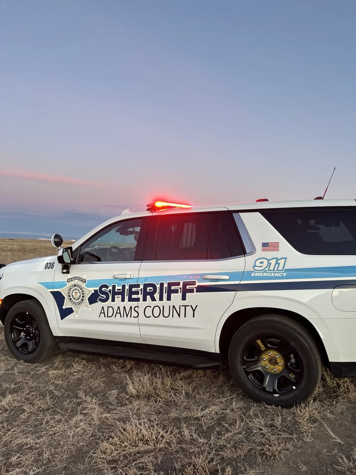 Adams County Sheriff patrol vehicle at sunset on the eastern plains