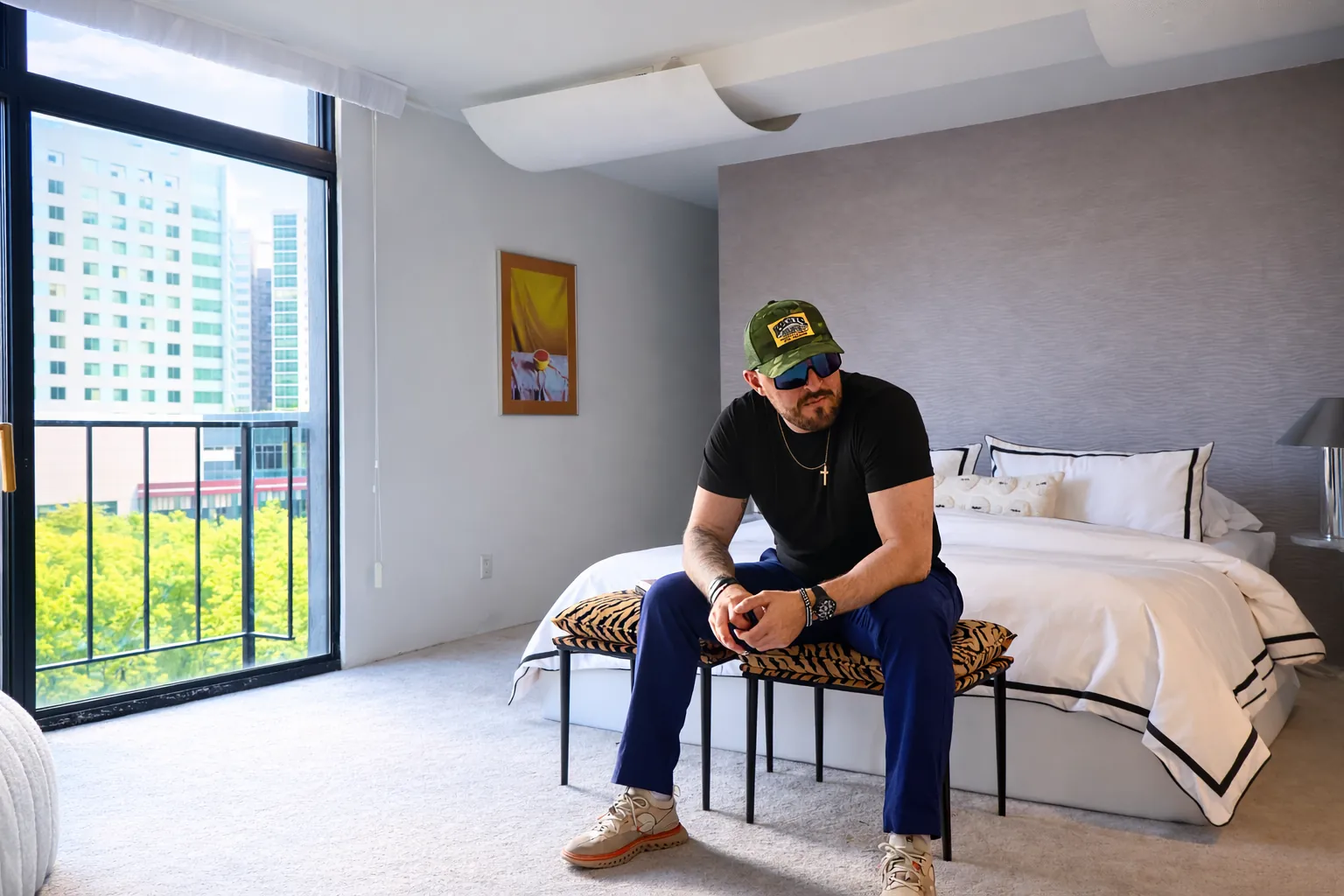 Rocky preparing listing marketing inside a bright bedroom